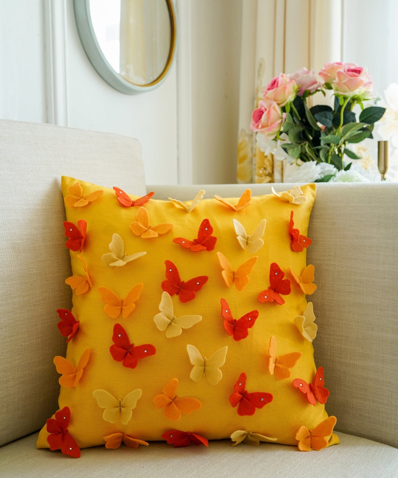 yellow pillow cover with yellow, orange, and red 3D butterflies
