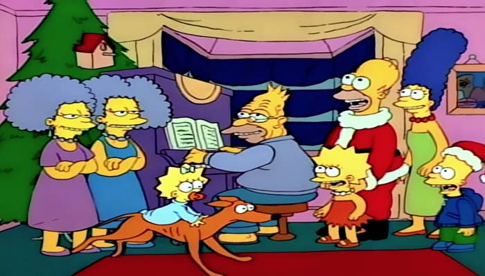 The entire Simpson family singing Christmas carols as Grandpa plays the piano and Maggie rides Santa&#x27;s Little Helper