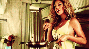 Beyonce stirring sauce in a pan