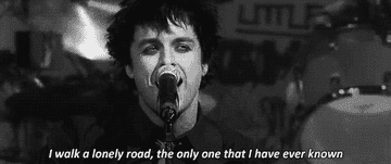 Billie Joe Armstrong of Green Day singing, &quot;I walk a lonely road, the only one that I have ever known&quot;