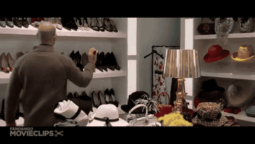 GIF of Andy in &quot;The Devil Wears Prada&quot; grabbing a pair of shoes
