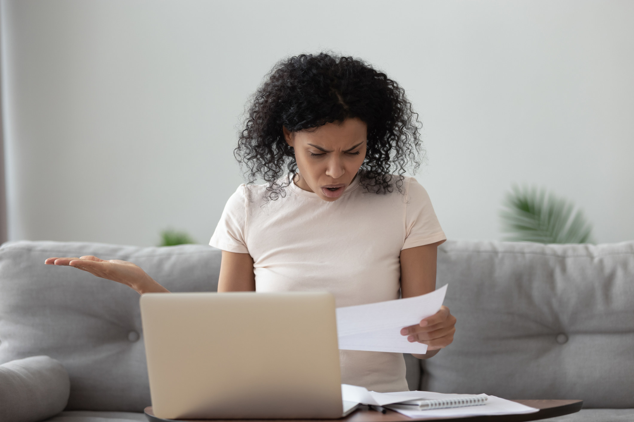 Person reading a bill and looking very shocked