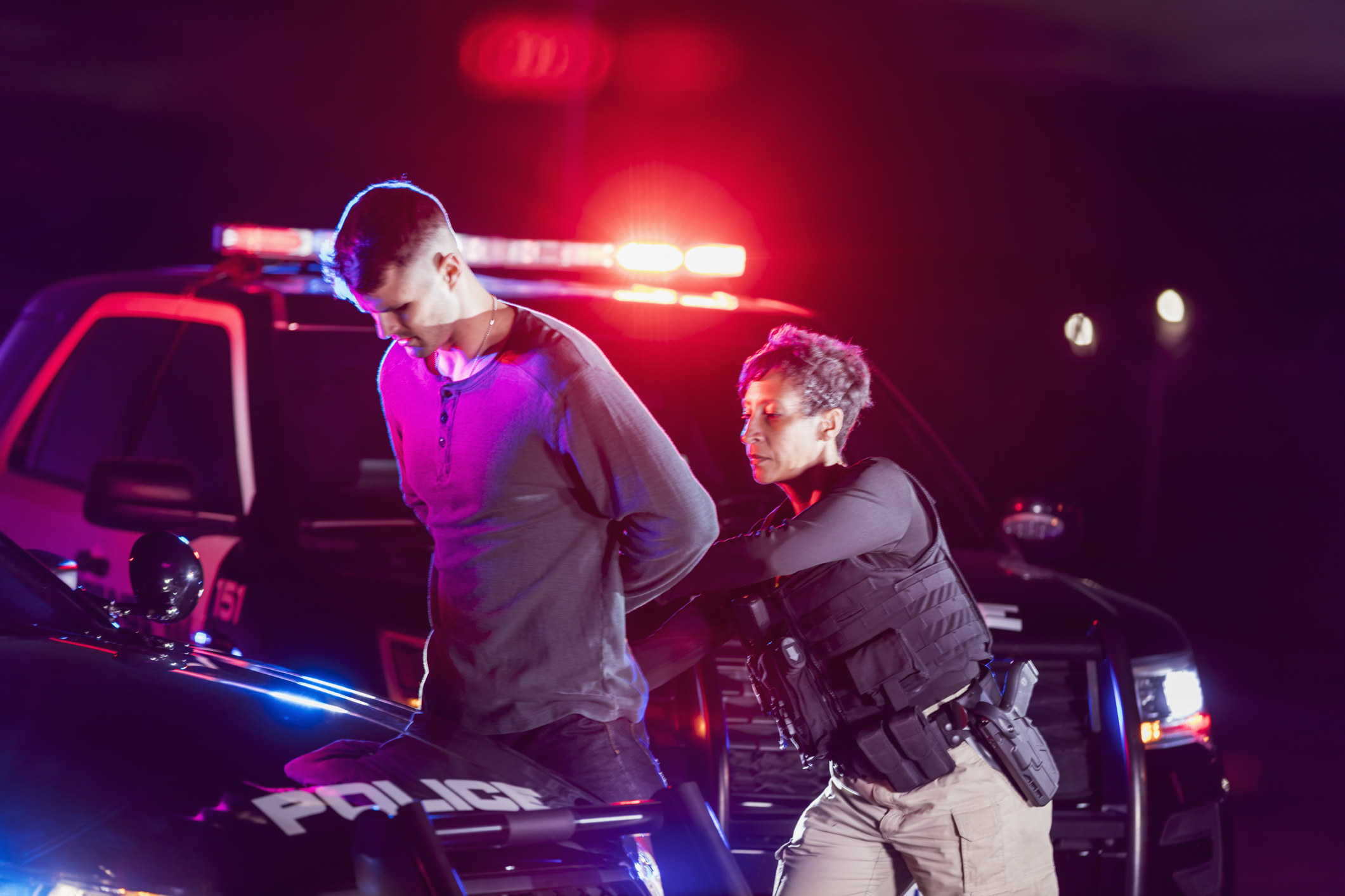 Police officer arresting a young man