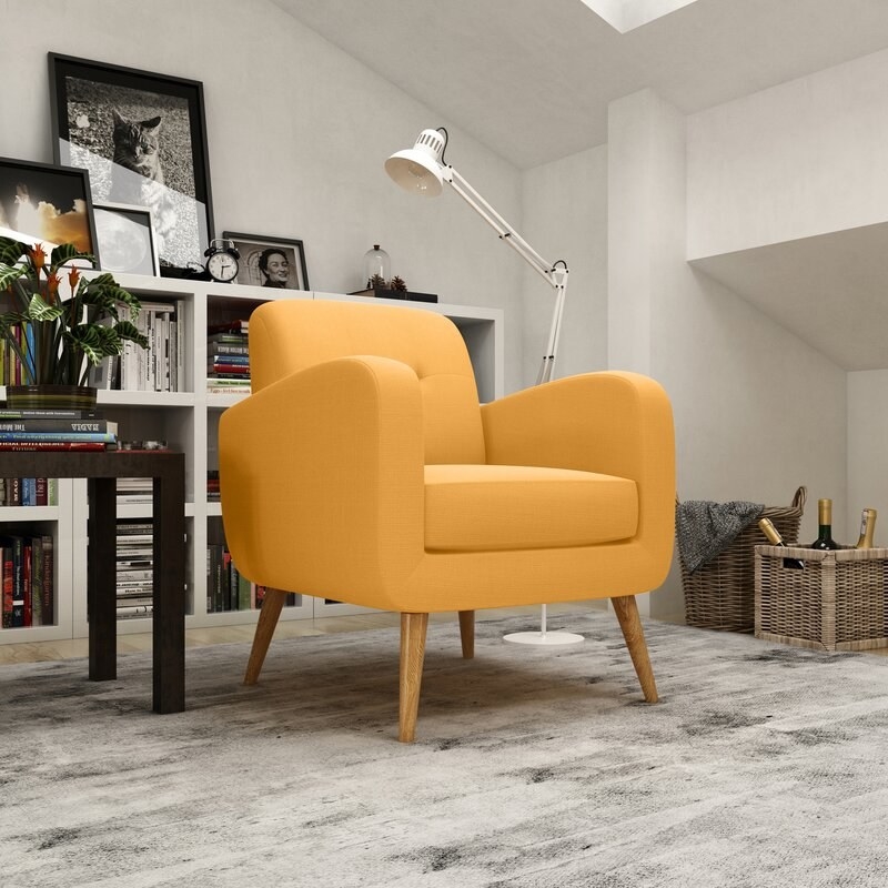 yellow armchair with wood legs in a living room