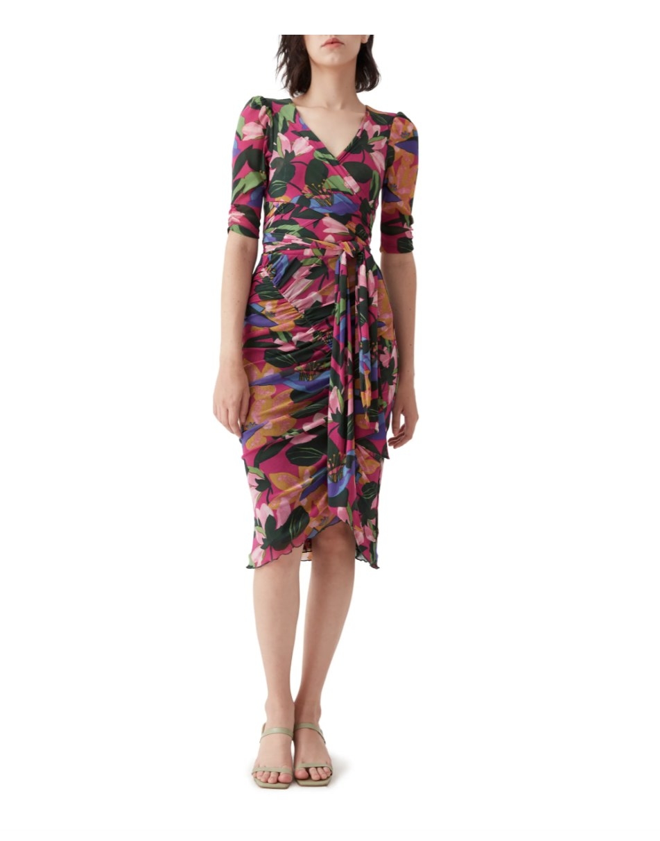 the pink, purple, orange floral dress on a model with sandals 