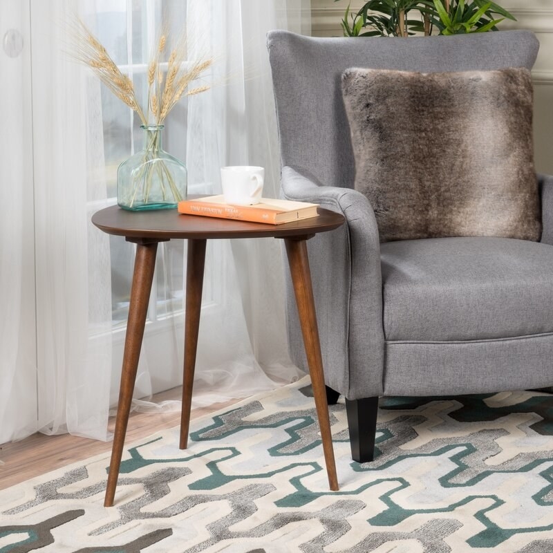 walnut end table with rounded triangular top and three legs