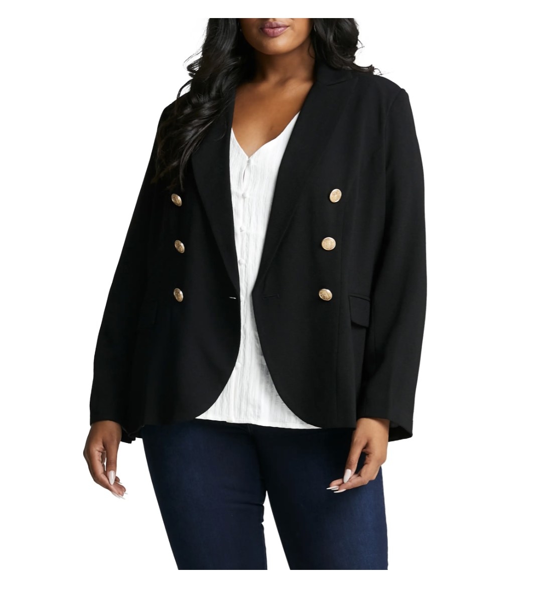 the blazer on a model with a white blouse and dark jeans 