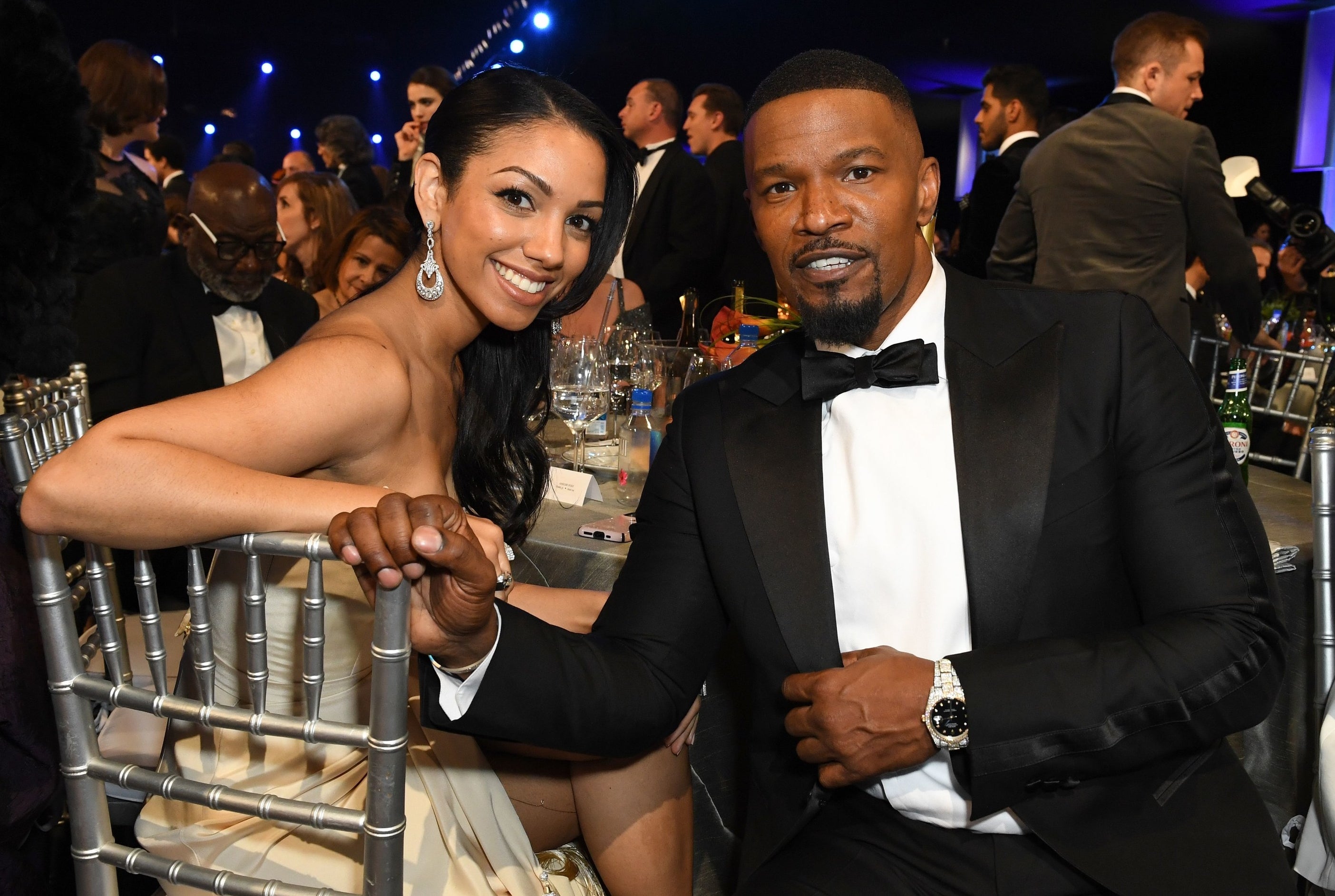 Jamie and Corinne sit together at a dinner table at an award show