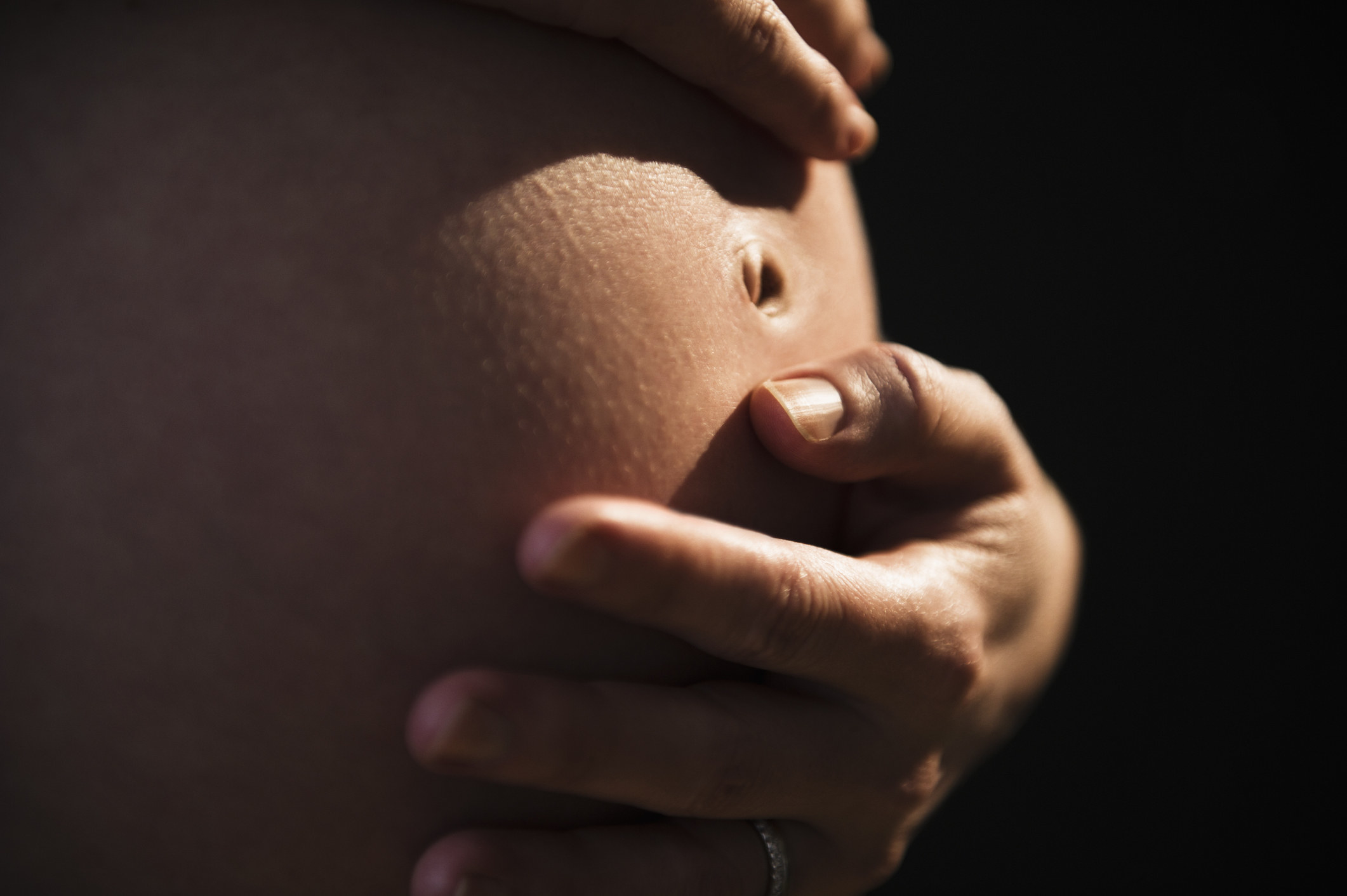 Woman holding her pregnant stomach