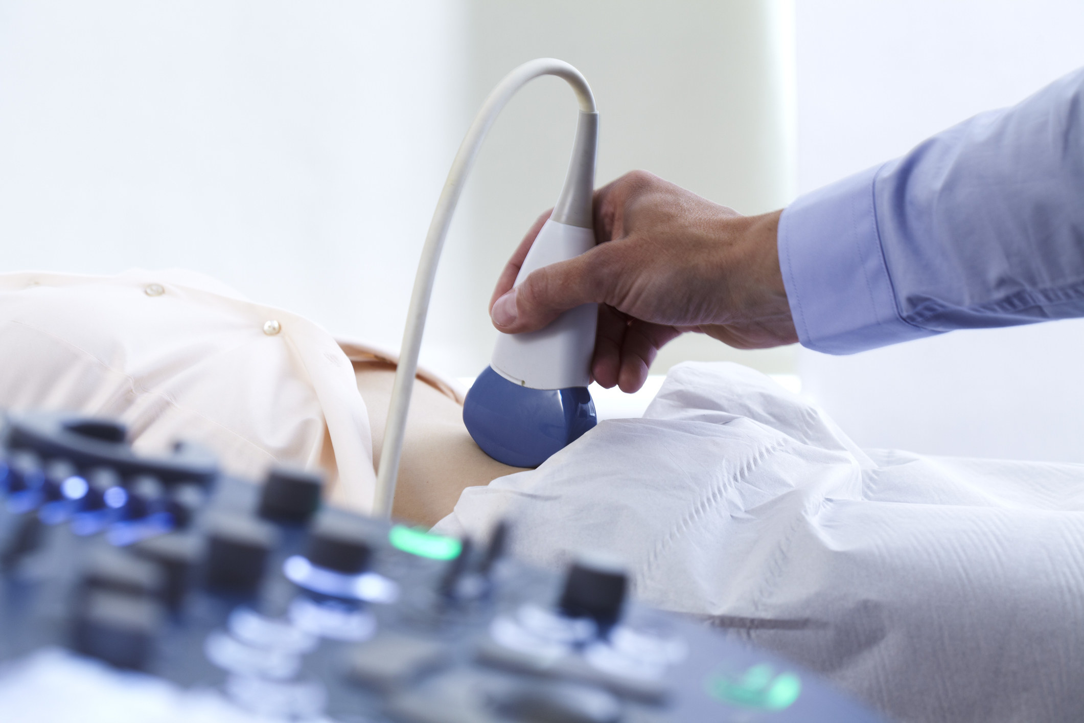 Doctor giving an ultrasound of someone's stomach