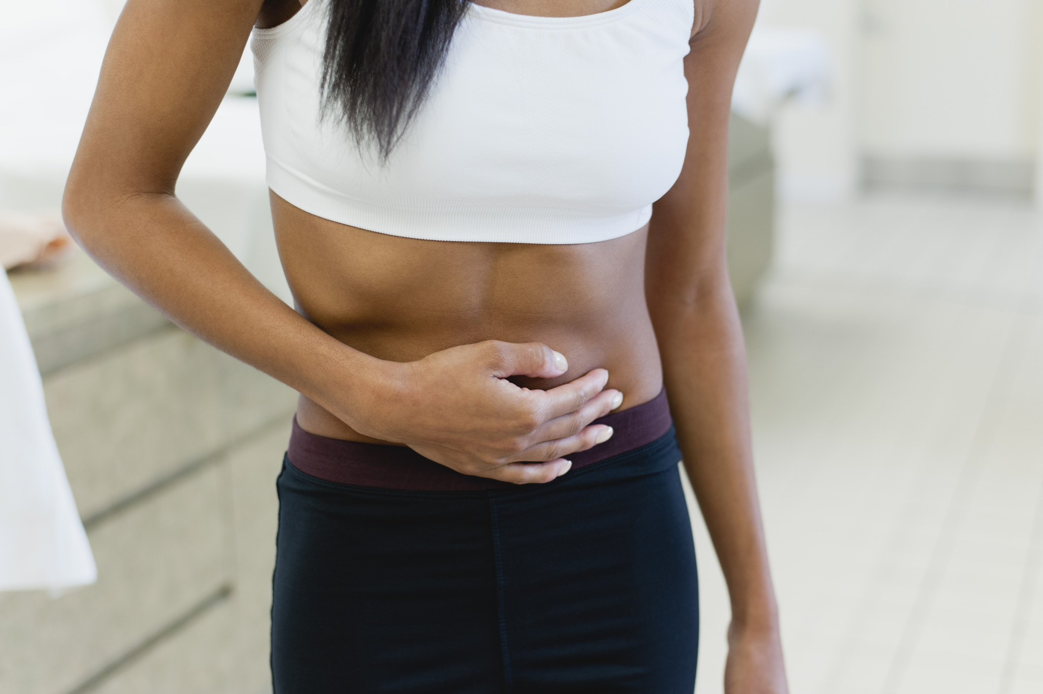 Woman holding her stomach in pain