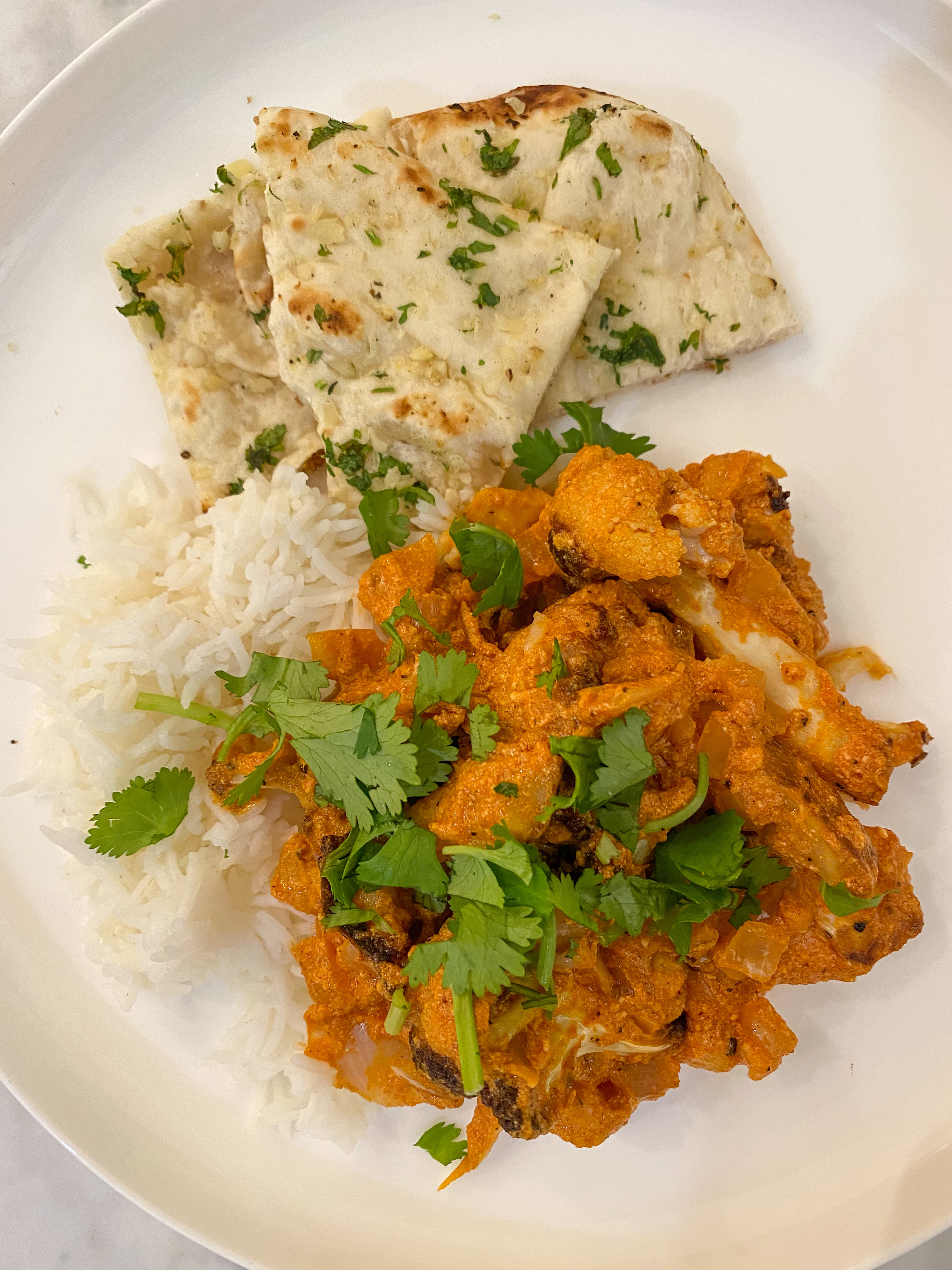 Butter cauliflower with rice and naan.