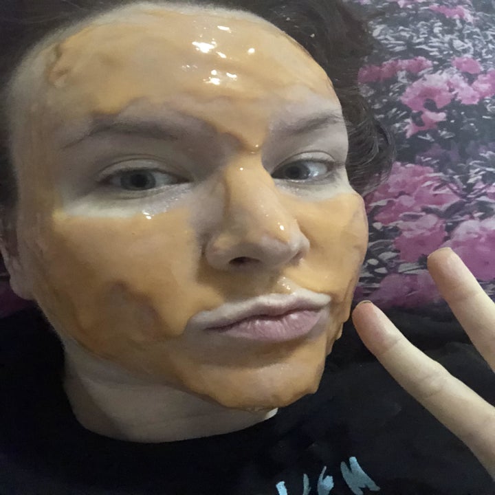 writer with a rubber gel face mask spread on face