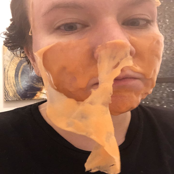 writer with the face mask half peeled off her face
