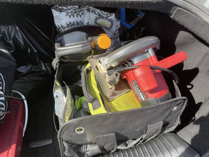 May&#x27;s trunk organizer filled with things like a circle saw and a jug of oil