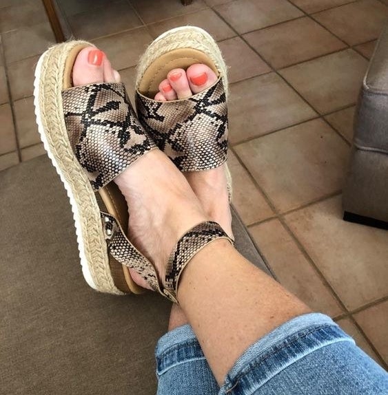 Reviewer wearing the espadrilles in leopard print