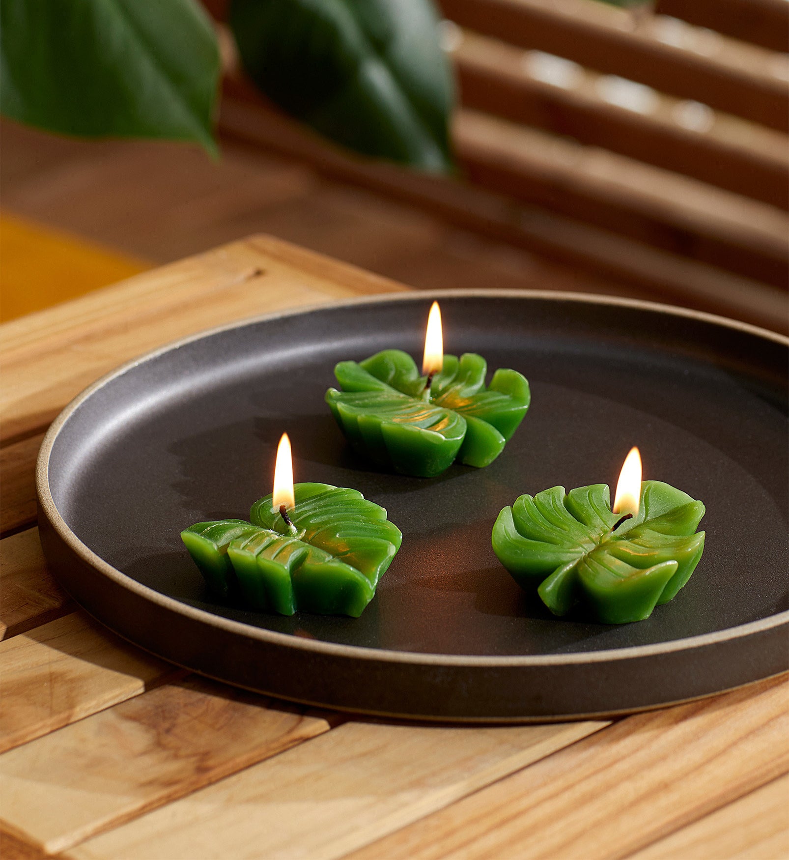 Three leaf-shaped candles on a tray 