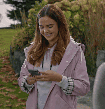Woman smiling and checking her phone