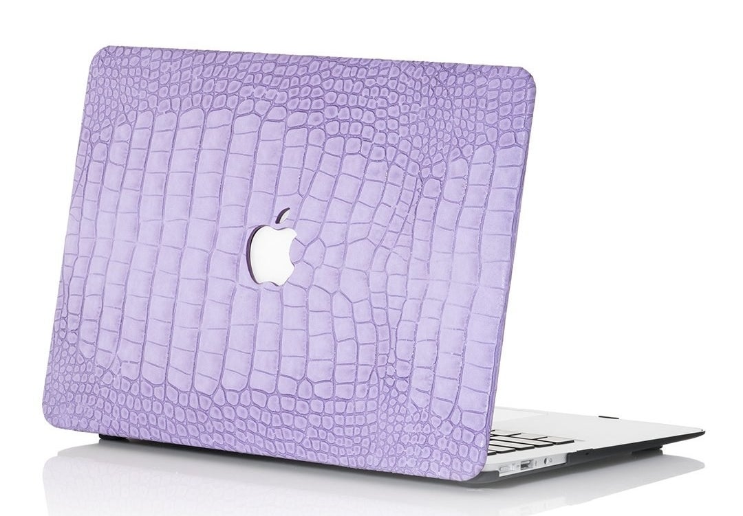 Apple laptop with a lavender cover in a faux-crocodile finish