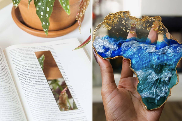 mirror bookmark on an open book page, hand holding up a gold and blue resin coaster in the shape of Africa