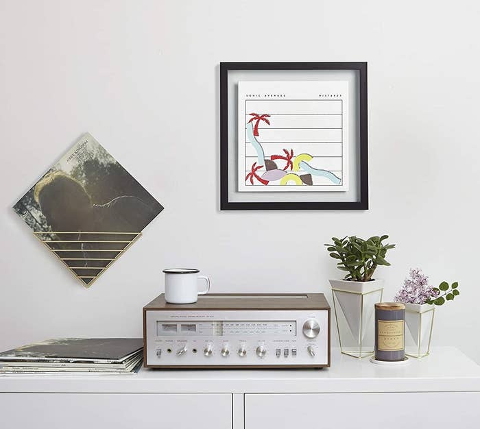 A framed record on a wall above a record player