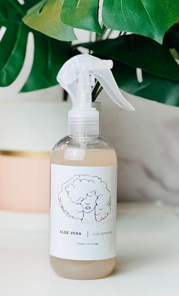 The bottle of curl spray