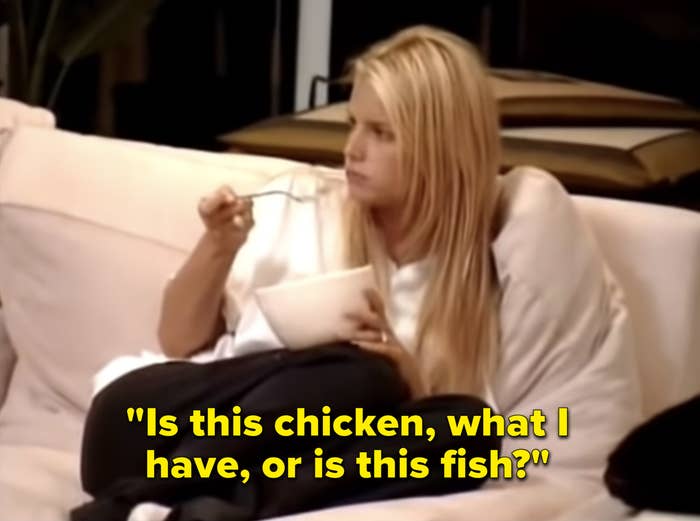 Jessica sitting on the couch eating a bowl of tuna and asking, &quot;Is this chicken, what i have, or is this fish?&quot;