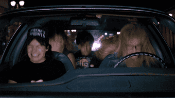 the cast of Wayne&#x27;s world jamming out in a car