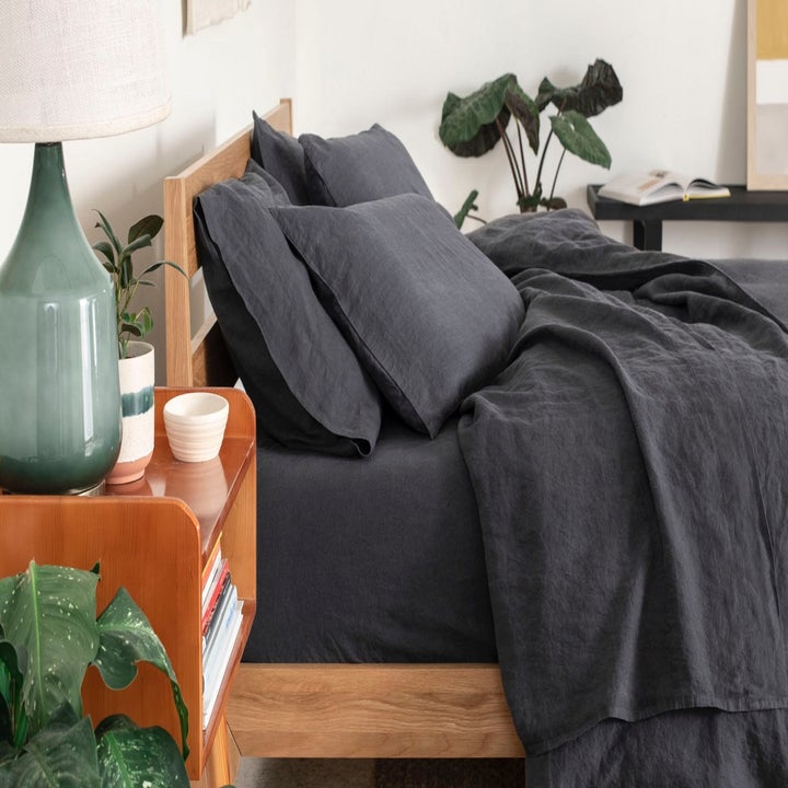 abed with the linen sheets in black on a bed 