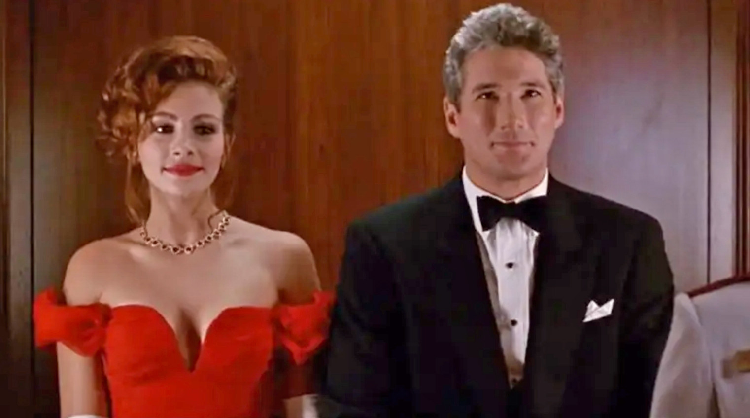 Julia Roberts and Richard Gere stand next to each other wearing fancy clothes as Vivian and Edward