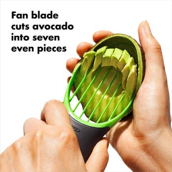 Hand slicing the avocado into seven neat pieces using the tool
