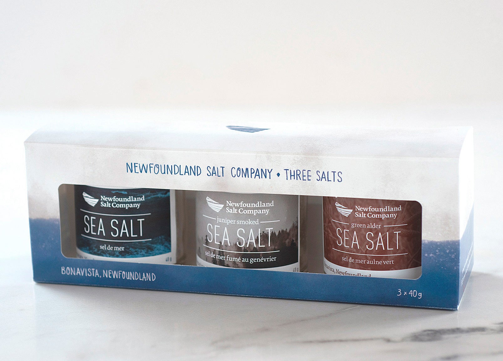 A trio of flavoured sea salts on a marble countertop