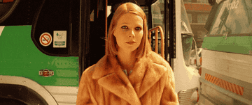 Gwyneth Paltrow slowly exits a bus while wearing a fabulous fur coat as Margot
