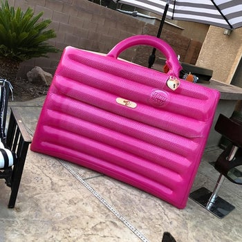 the pink purse-shaped pool float