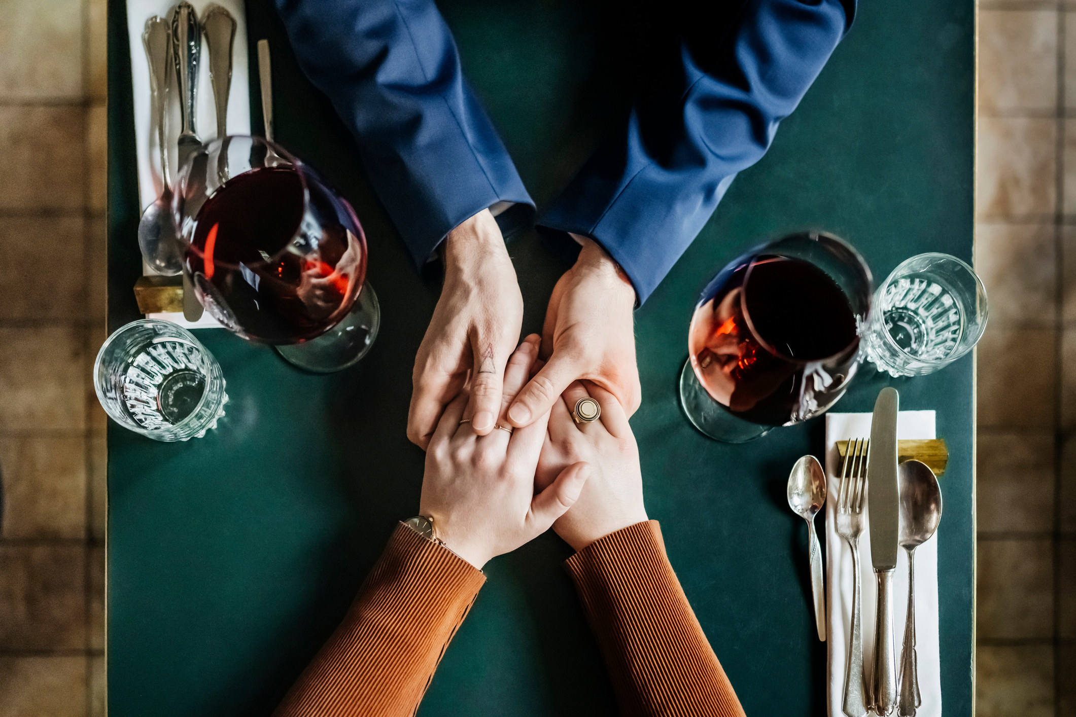 holding hands across a table