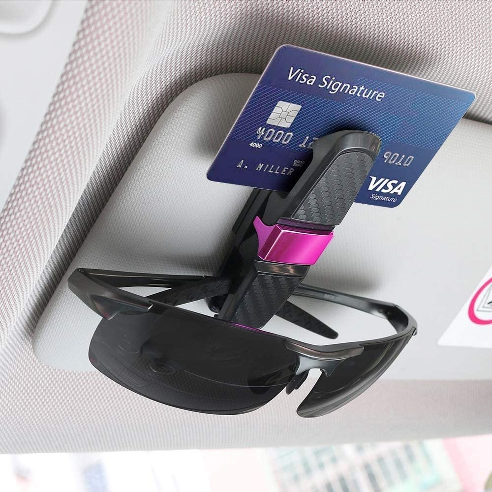 a pair of sunglasses and credit card held by the clip