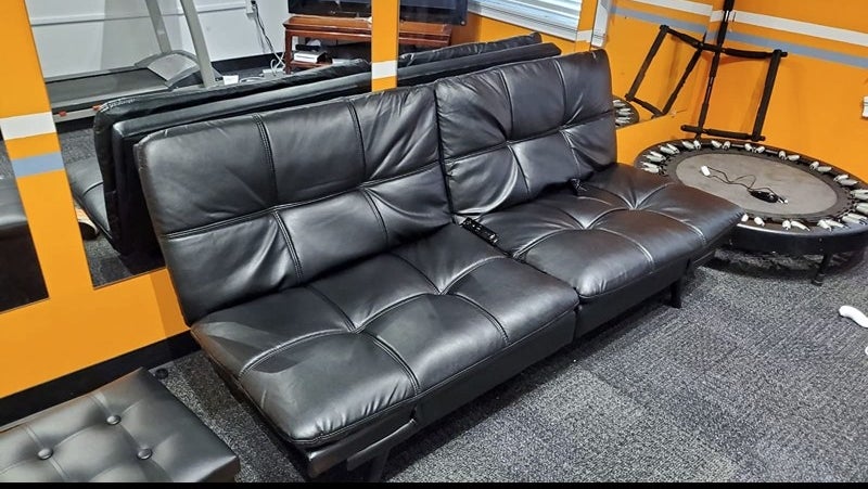 A faux-leather futon in a reviewer&#x27;s home
