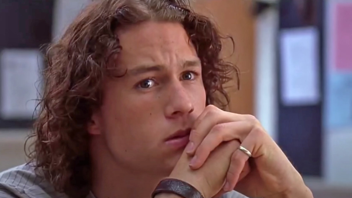 Heath Ledger clasps his hands in front of his mouth as tears form in his eyes as Patrick