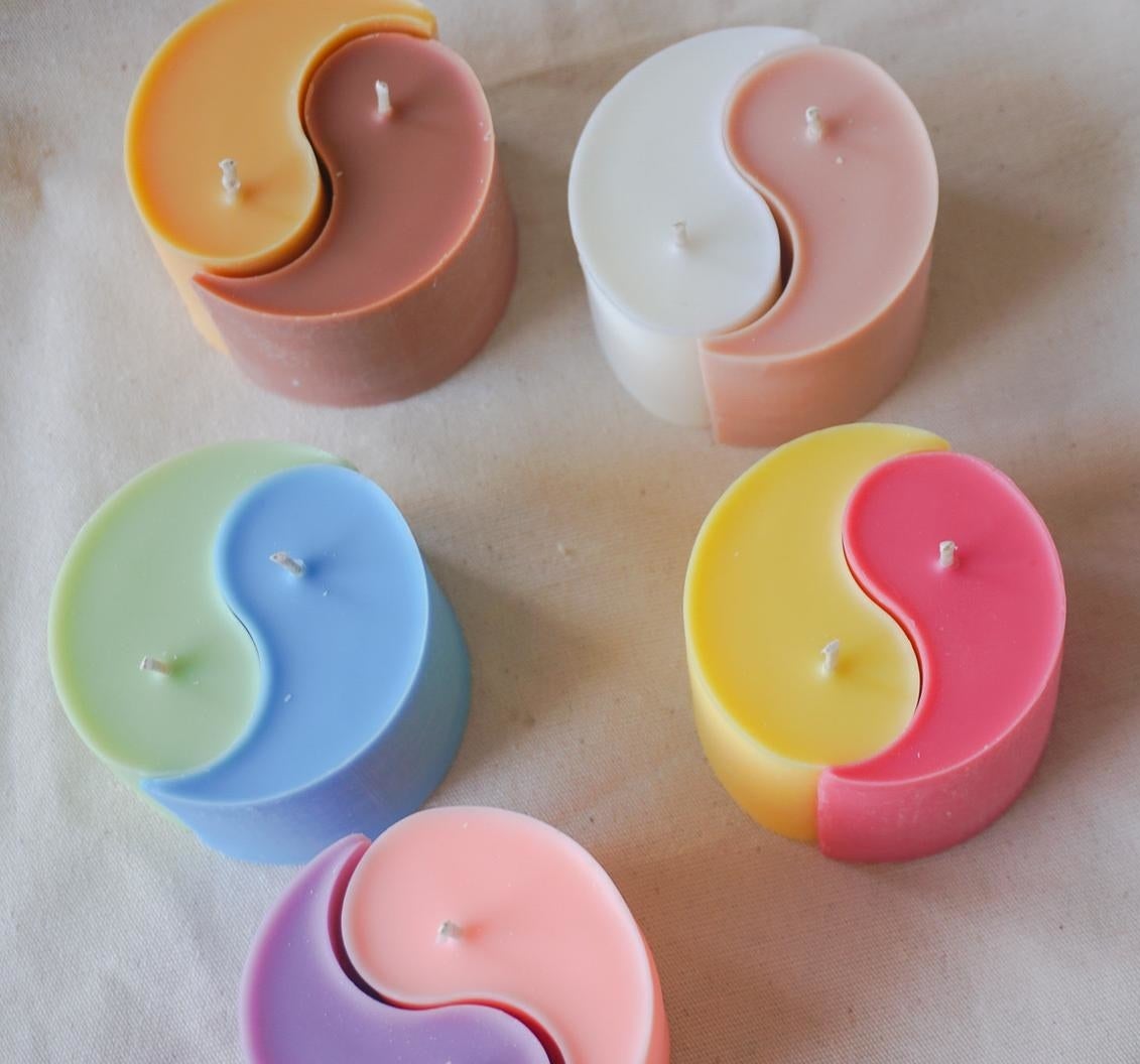 the candles in orange, brown, white, pink, yellow, purple, green, and blue