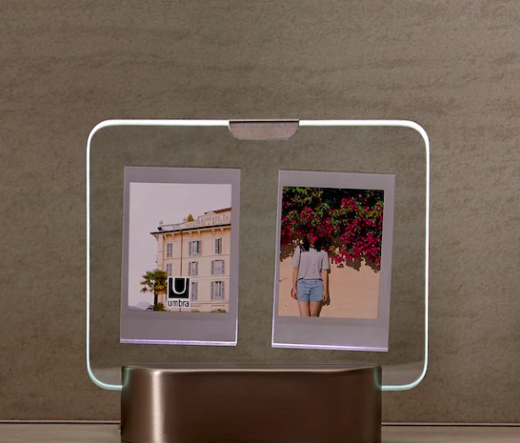 A light-up picture frame holding two photos in the glass
