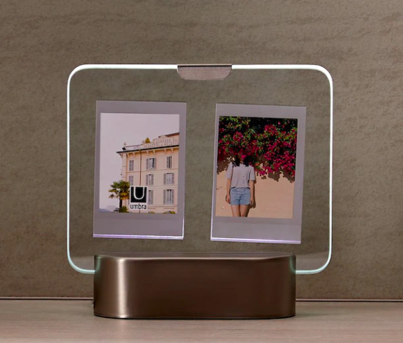 A light-up picture frame holding two photos in the glass