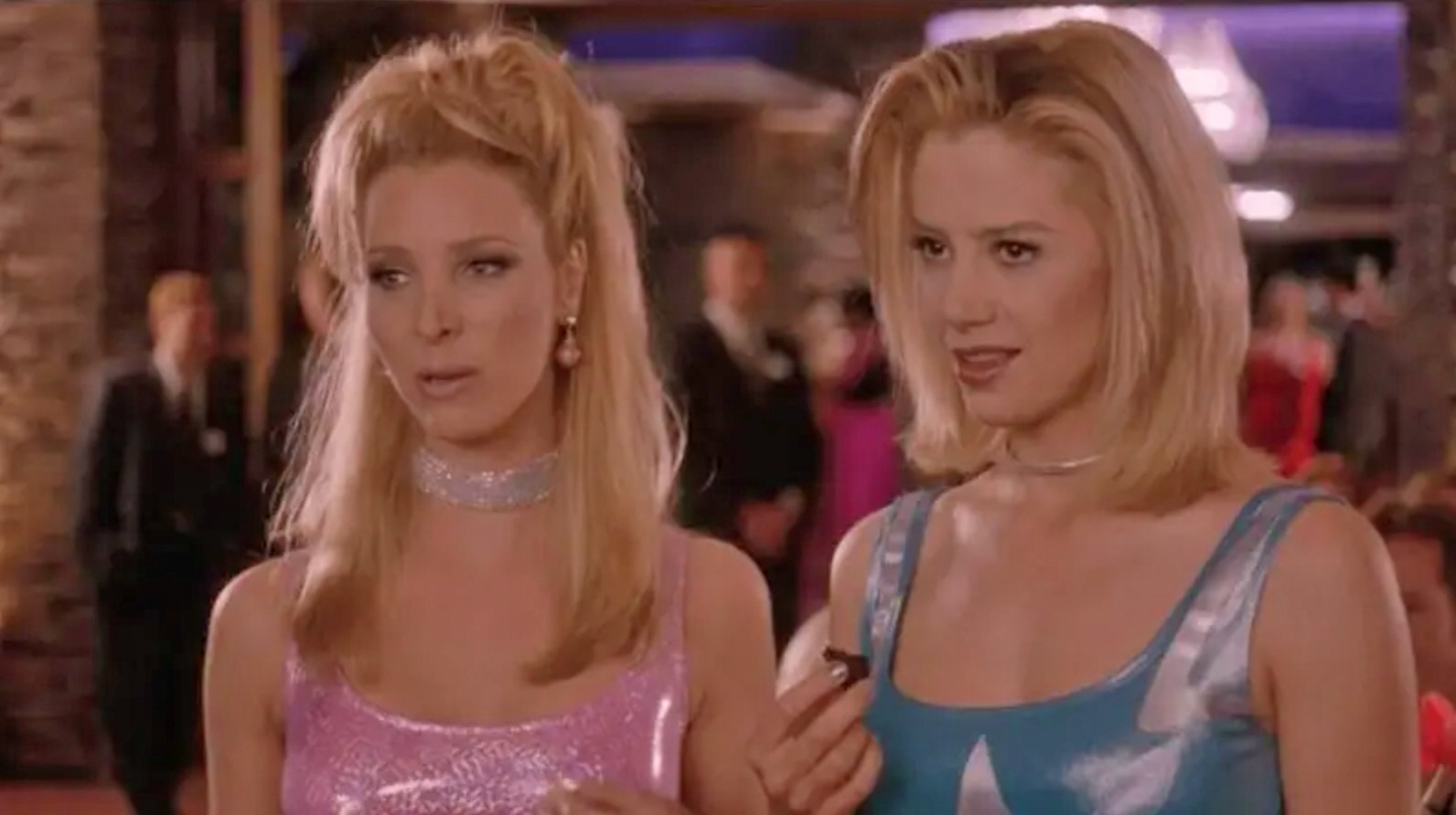 Lisa Kudrow and Mira Sorvino wearing sparkly dresses and chokers as Michele and Romy