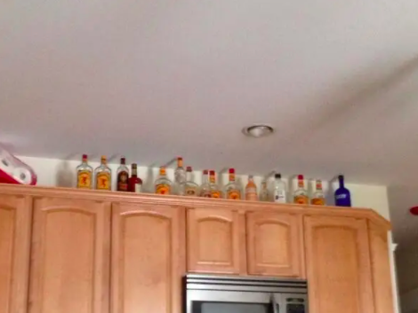 bottles of liquors on cabinets