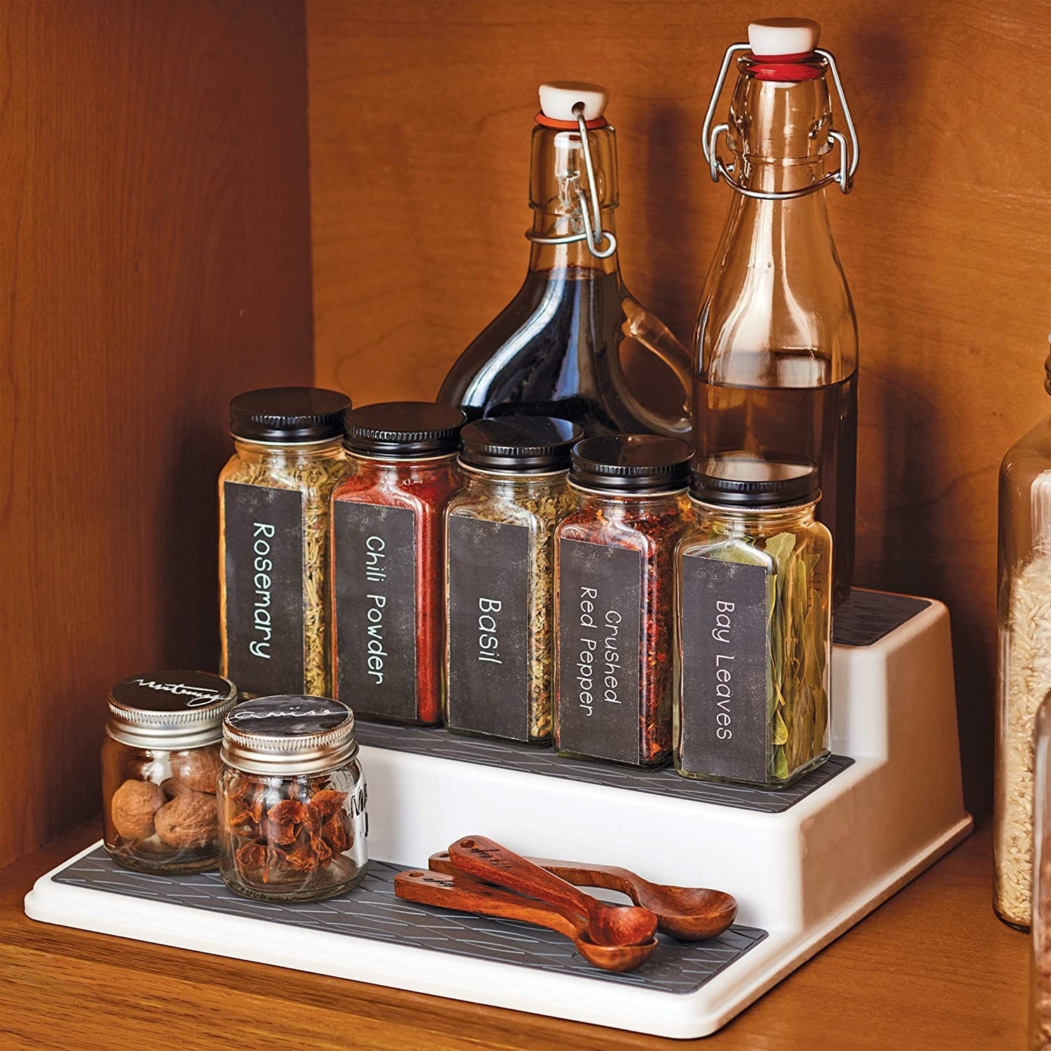 Various bottles and spices placed on three-tiered stand