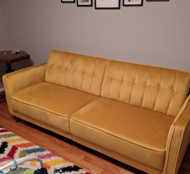A yellow futon in a reviewer&#x27;s home