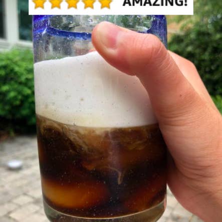 Reviewer's picture of frothy iced coffee with five-star caption 