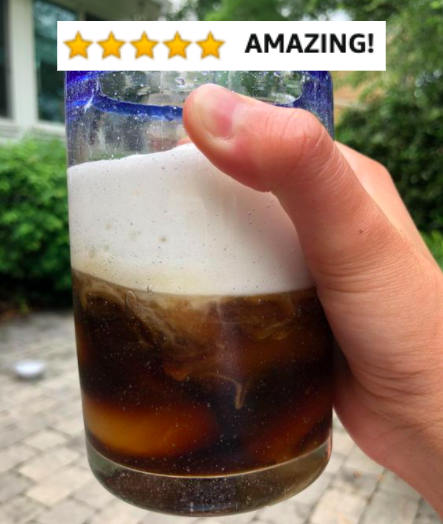 Reviewer&#x27;s picture of frothy iced coffee with five-star caption &quot;amazing!&quot;