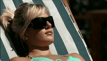 Heidi from the hills wearing sunglasses and sunbathing