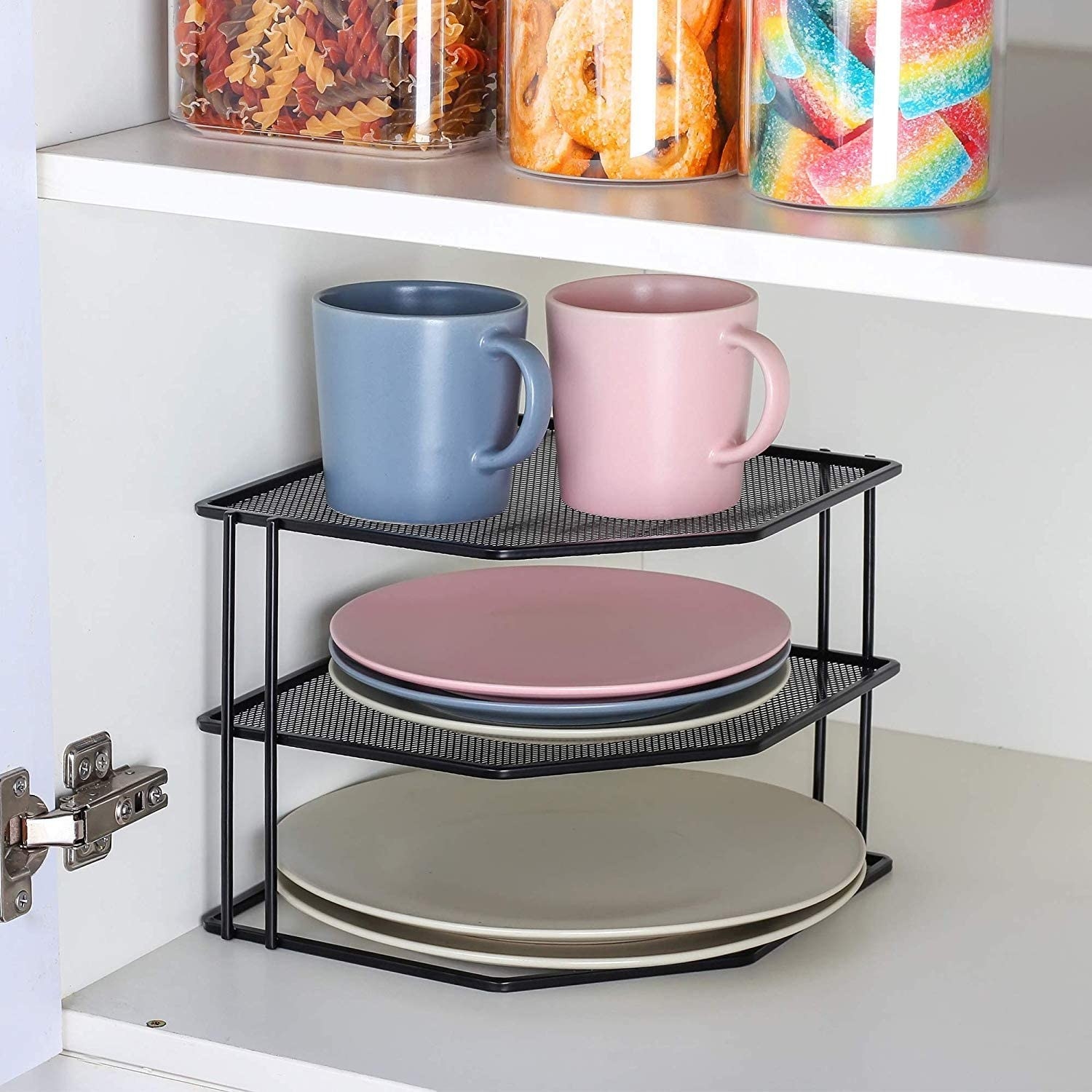 Dishes and cups placed on corner shelf in cabinet