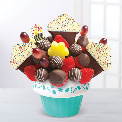 cupcake-shaped pieces of chocolate, grapes, and assorted fruit in a teal cupcake-shaped tin
